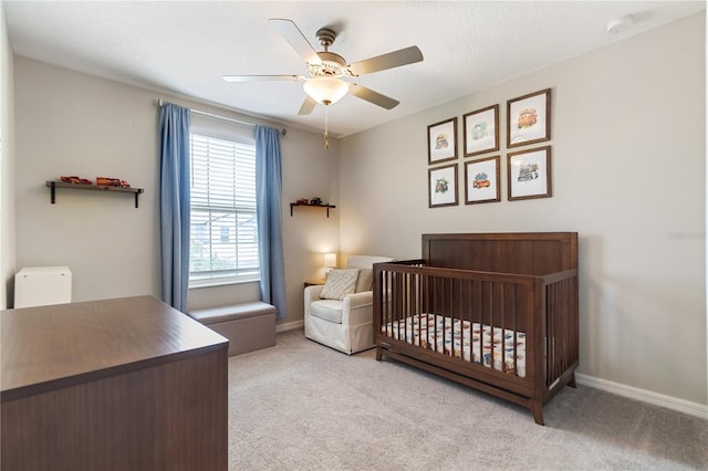 6180 Spring Crayfish Ave, New Port Richey, FL 34653 - carpeted bedroom with baseboards, a ceiling fan, and a crib