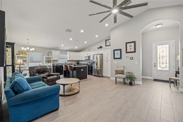 6741 51st Way N, Pinellas Park, FL 33781 - living room featuring arched walkways, ceiling fan, high vaulted ceiling, recessed lighting, and a chandelier