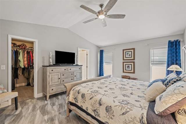 6741 51st Way N, Pinellas Park, FL 33781 - bedroom with a spacious closet, vaulted ceiling, a closet, a ceiling fan, and connected bathroom