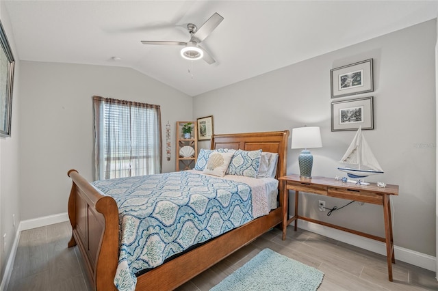 6741 51st Way N, Pinellas Park, FL 33781 - bedroom featuring baseboards, wood finished floors, vaulted ceiling, and ceiling fan