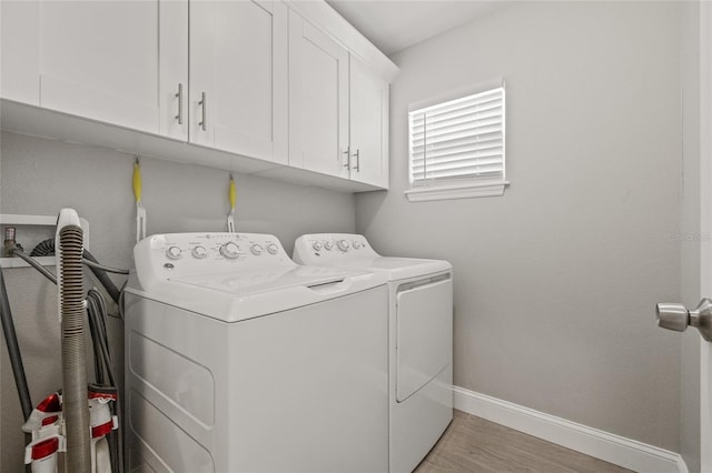 6741 51st Way N, Pinellas Park, FL 33781 - laundry room featuring independent washer and dryer, cabinet space, baseboards, and light wood finished floors