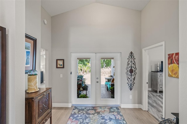 6741 51st Way N, Pinellas Park, FL 33781 - foyer entrance with light wood finished floors, french doors, high vaulted ceiling, and baseboards