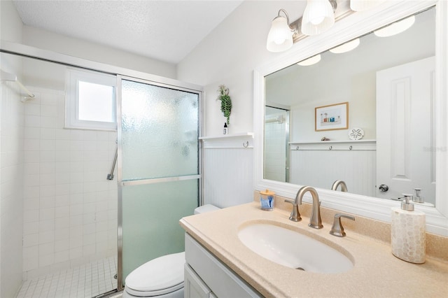 6075 Shore Blvd S Unit 215, Gulfport, FL 33707 - bathroom featuring a shower stall, vanity, toilet, and wainscoting