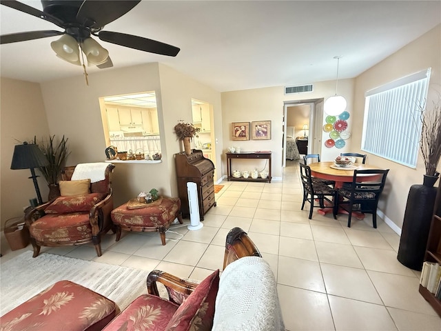 102 Cambridge Trl Unit 230, Sun City Center, FL 33573 - living area featuring light tile patterned flooring, ceiling fan, and baseboards