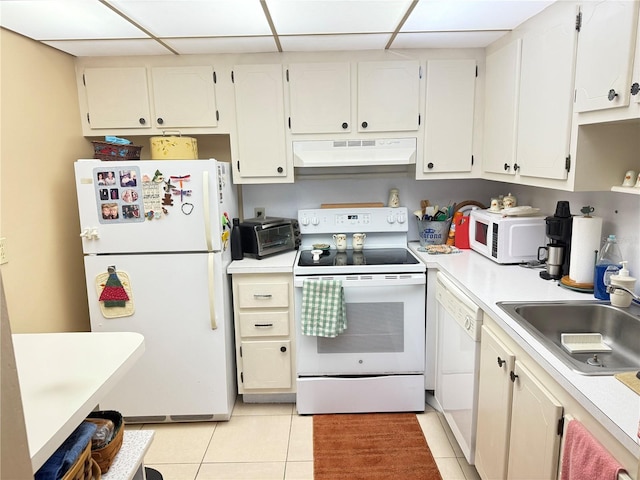 102 Cambridge Trl Unit 230, Sun City Center, FL 33573 - kitchen featuring white appliances, under cabinet range hood, a sink, light tile patterned floors, and light countertops