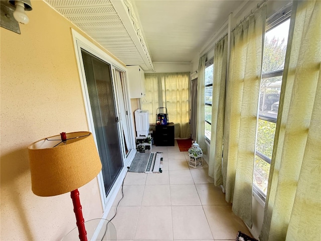 102 Cambridge Trl Unit 230, Sun City Center, FL 33573 - sunroom with tile patterned floors and a textured wall