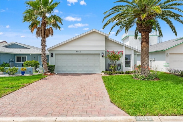 4012 Marine Pkwy, New Port Richey, FL 34652 - view of front of home with an attached garage, decorative driveway, and stucco siding