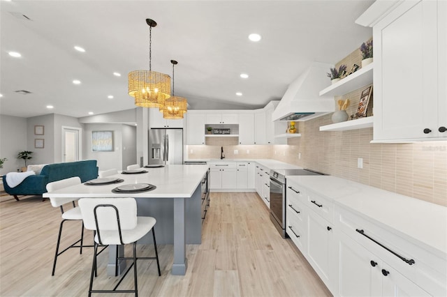 4012 Marine Pkwy, New Port Richey, FL 34652 - kitchen with open shelves, appliances with stainless steel finishes, light wood-type flooring, a sink, and a breakfast bar