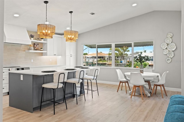 4012 Marine Pkwy, New Port Richey, FL 34652 - kitchen featuring premium range hood, baseboards, a chandelier, white cabinets, and recessed lighting