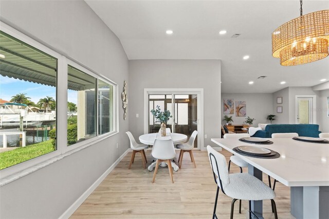 4012 Marine Pkwy, New Port Richey, FL 34652 - dining area with light wood finished floors, recessed lighting, baseboards, and a chandelier
