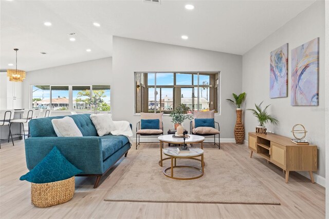 4012 Marine Pkwy, New Port Richey, FL 34652 - living area with lofted ceiling, light wood-style floors, a chandelier, baseboards, and recessed lighting