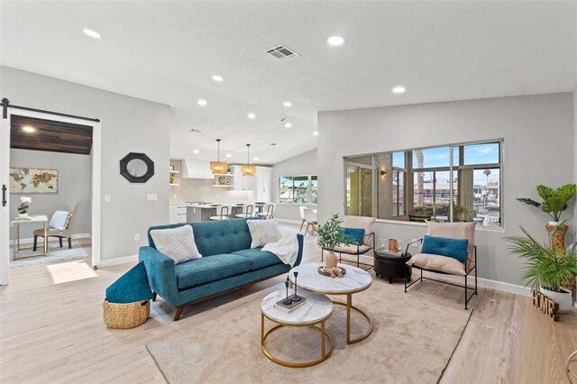 4012 Marine Pkwy, New Port Richey, FL 34652 - living area featuring light wood finished floors, vaulted ceiling, baseboards, and recessed lighting