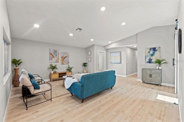 4012 Marine Pkwy, New Port Richey, FL 34652 - living area featuring light wood finished floors, baseboards, lofted ceiling, and recessed lighting