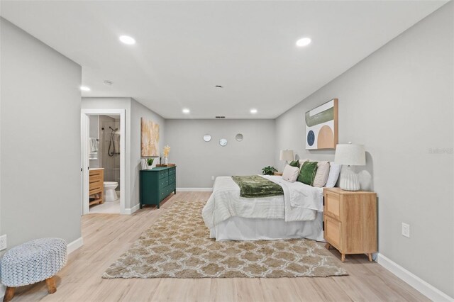 4012 Marine Pkwy, New Port Richey, FL 34652 - bedroom with light wood finished floors, baseboards, recessed lighting, and ensuite bath