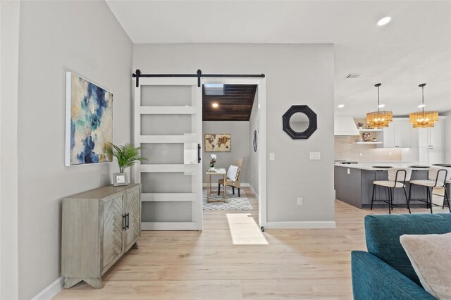 4012 Marine Pkwy, New Port Richey, FL 34652 - living area featuring a barn door, light wood-type flooring, a chandelier, recessed lighting, and baseboards