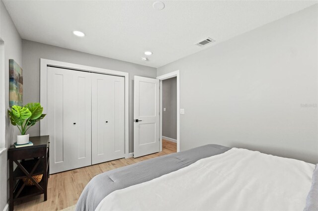 4012 Marine Pkwy, New Port Richey, FL 34652 - bedroom with light wood-type flooring, a closet, recessed lighting, and baseboards