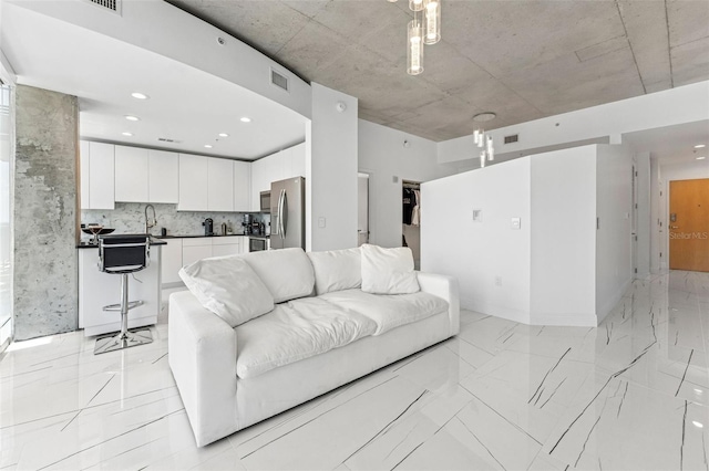 777 N Ashley Dr Unit 1506, Tampa, FL 33602 - living room with light marble finish floors, recessed lighting, and baseboards
