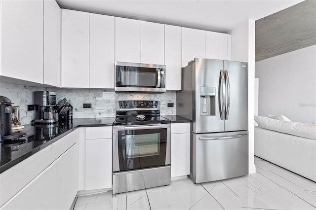 777 N Ashley Dr Unit 1506, Tampa, FL 33602 - kitchen with appliances with stainless steel finishes, decorative backsplash, white cabinetry, and light marble finish floors