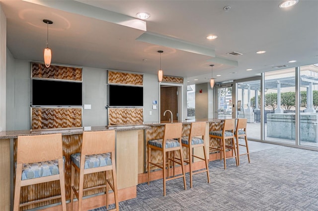 777 N Ashley Dr Unit 1506, Tampa, FL 33602 - bar featuring recessed lighting, hanging light fixtures, and a sink