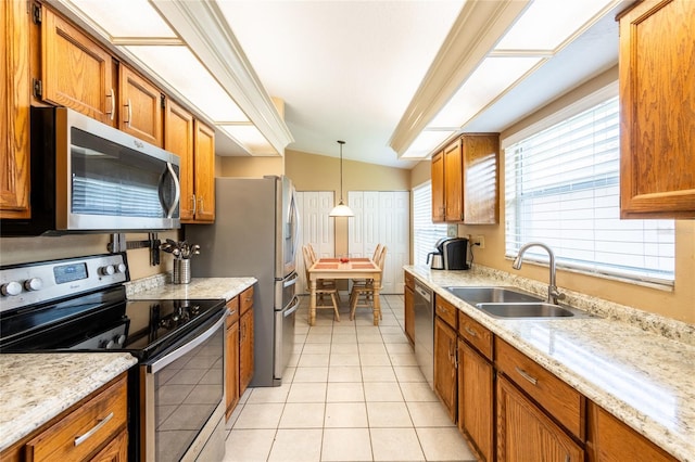 2024 Glen Forge St, Brandon, FL 33511 - kitchen with appliances with stainless steel finishes, a sink, brown cabinetry, and plenty of natural light