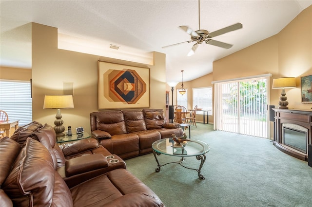 2024 Glen Forge St, Brandon, FL 33511 - carpeted living area with vaulted ceiling, ceiling fan, and a glass covered fireplace