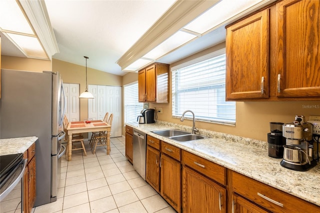 2024 Glen Forge St, Brandon, FL 33511 - kitchen featuring a sink, appliances with stainless steel finishes, brown cabinets, light tile patterned floors, and lofted ceiling