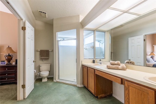 2024 Glen Forge St, Brandon, FL 33511 - ensuite bathroom with a stall shower, double vanity, toilet, a textured ceiling, and baseboards