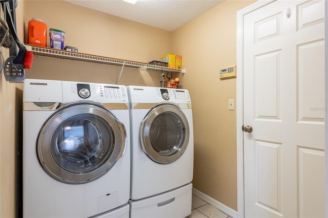 2024 Glen Forge St, Brandon, FL 33511 - washroom with separate washer and dryer, light tile patterned flooring, and baseboards