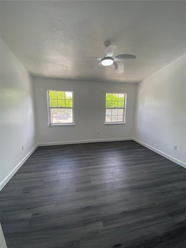 8708 Cobbler Pl, Tampa, FL 33615 - empty room featuring dark wood-type flooring, ceiling fan, a textured ceiling, and baseboards
