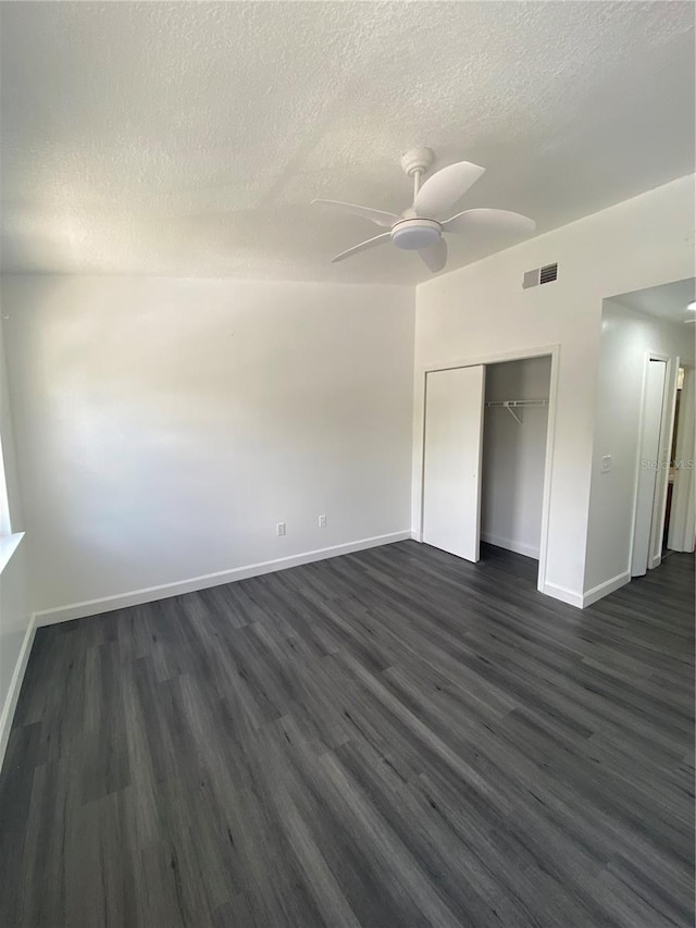 8708 Cobbler Pl, Tampa, FL 33615 - unfurnished room featuring ceiling fan, a textured ceiling, dark wood finished floors, and baseboards
