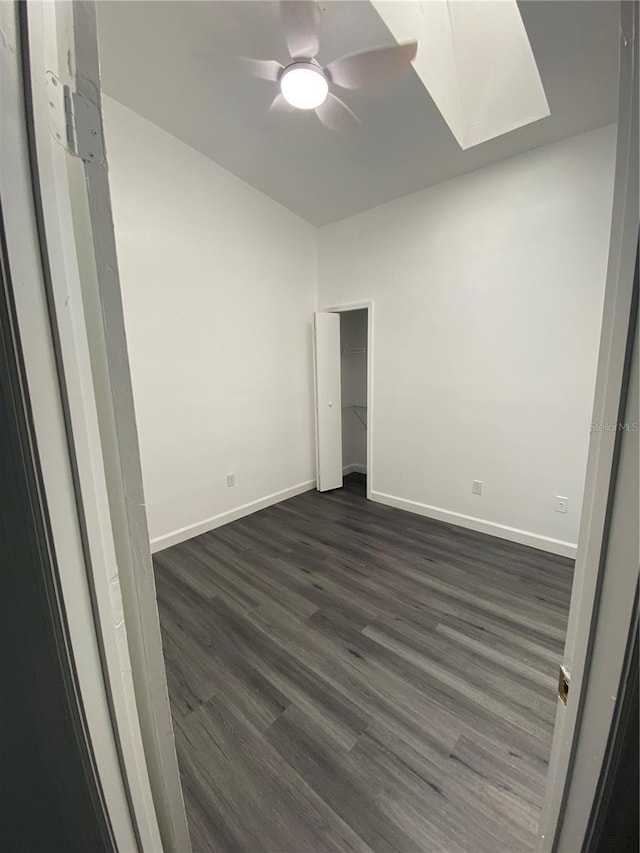 8708 Cobbler Pl, Tampa, FL 33615 - unfurnished bedroom with dark wood finished floors, baseboards, a skylight, and ceiling fan