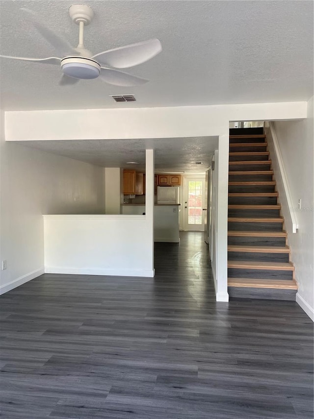8708 Cobbler Pl, Tampa, FL 33615 - unfurnished living room with baseboards, a ceiling fan, a textured ceiling, dark wood-style floors, and stairway