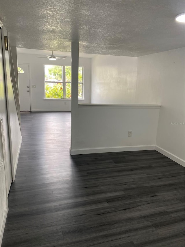 8708 Cobbler Pl, Tampa, FL 33615 - unfurnished room featuring dark wood-type flooring, baseboards, and a textured ceiling