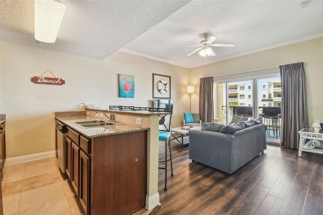 10315 Gulf Blvd Unit 302, Saint Petersburg, FL 33706 - kitchen with a sink, a breakfast bar, ceiling fan, open floor plan, and ornamental molding