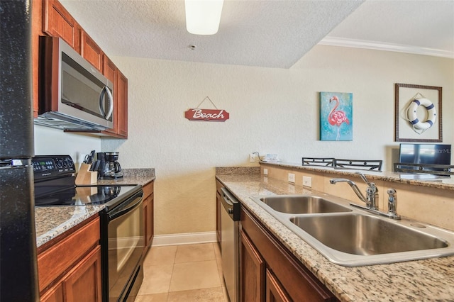 10315 Gulf Blvd Unit 302, Saint Petersburg, FL 33706 - kitchen featuring black appliances, a sink, crown molding, baseboards, and a textured ceiling