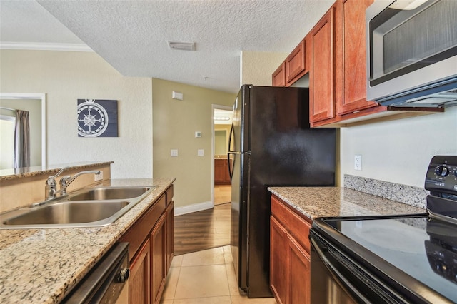 10315 Gulf Blvd Unit 302, Saint Petersburg, FL 33706 - kitchen featuring stainless steel microwave, electric range, a sink, freestanding refrigerator, and ornamental molding