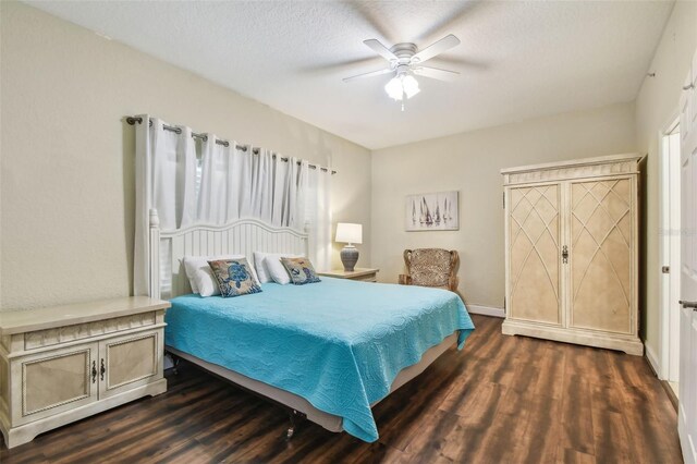 10315 Gulf Blvd Unit 302, Saint Petersburg, FL 33706 - bedroom featuring dark wood finished floors, ceiling fan, baseboards, and a textured ceiling
