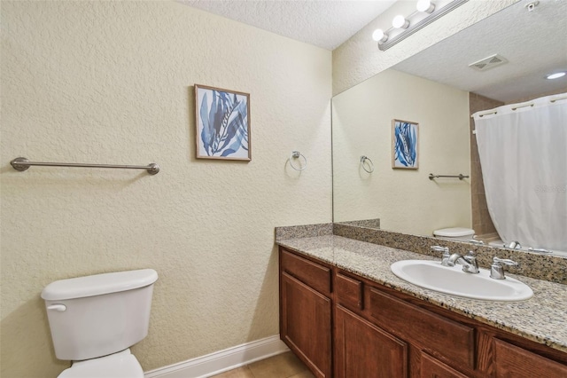10315 Gulf Blvd Unit 302, Saint Petersburg, FL 33706 - full bathroom featuring toilet, a textured ceiling, vanity, tile patterned flooring, and a shower with curtain