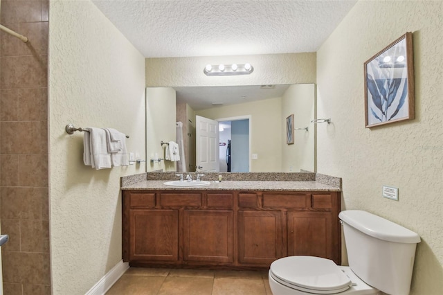 10315 Gulf Blvd Unit 302, Saint Petersburg, FL 33706 - full bath with a textured wall, toilet, a textured ceiling, vanity, and tile patterned flooring