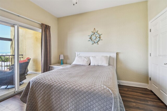 10315 Gulf Blvd Unit 302, Saint Petersburg, FL 33706 - bedroom with multiple windows, wood finished floors, access to outside, and baseboards