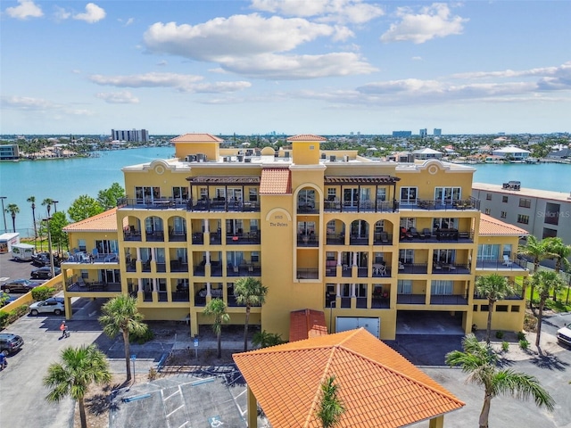 10315 Gulf Blvd Unit 302, Saint Petersburg, FL 33706 - view of apartment building / complex with a water view, uncovered parking, and a view of city
