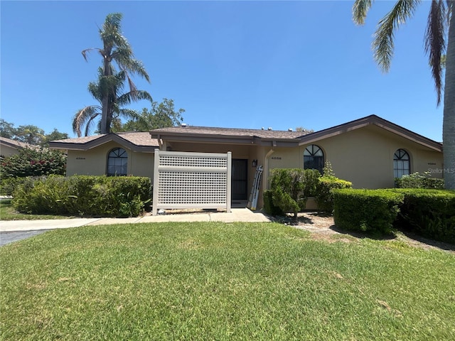 4558 Morningside Unit 43, Sarasota, FL 34235 - ranch-style house with stucco siding and a front lawn