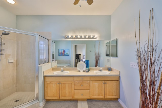 bathroom featuring a stall shower, a bath, double vanity, a ceiling fan, and tile patterned flooring