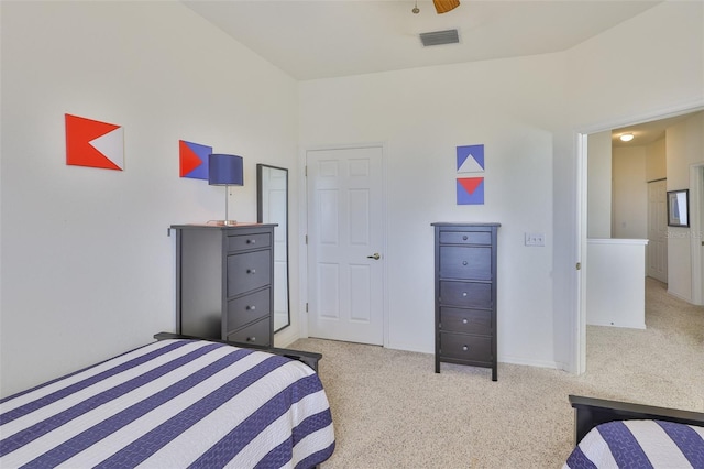 bedroom featuring light carpet and baseboards