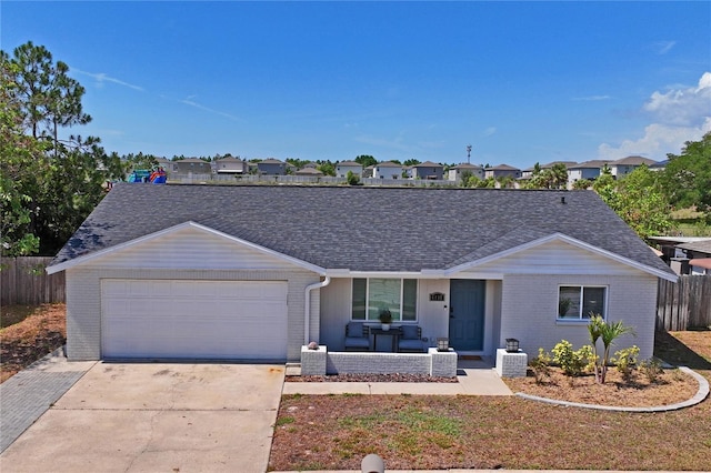 6137 Halifax Dr, New Port Richey, FL 34653 - single story home featuring brick siding, an attached garage, a shingled roof, concrete driveway, and an outdoor living space