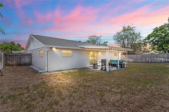 6137 Halifax Dr, New Port Richey, FL 34653 - back of house at dusk featuring a patio area and stucco siding