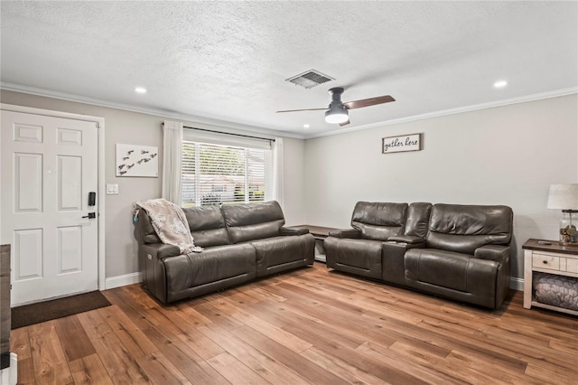 6137 Halifax Dr, New Port Richey, FL 34653 - living room with light wood-style floors, ceiling fan, ornamental molding, a textured ceiling, and recessed lighting