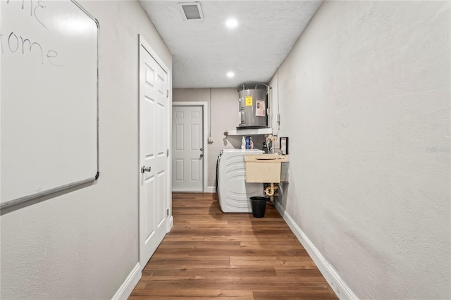 6137 Halifax Dr, New Port Richey, FL 34653 - hallway featuring water heater, wood finished floors, baseboards, recessed lighting, and washer / clothes dryer