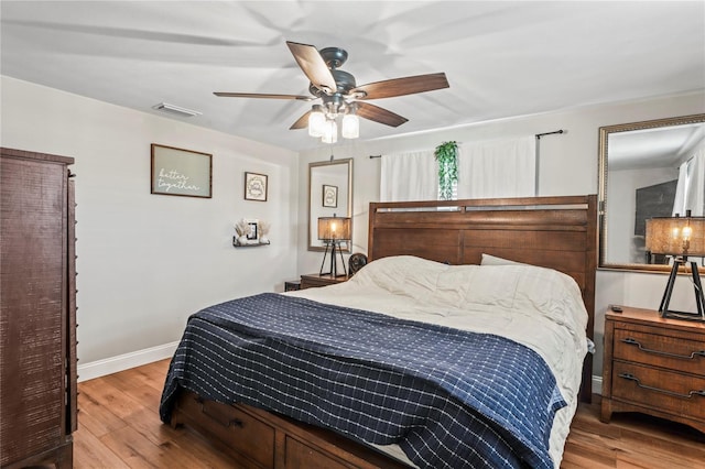 6137 Halifax Dr, New Port Richey, FL 34653 - bedroom with wood finished floors, baseboards, and ceiling fan