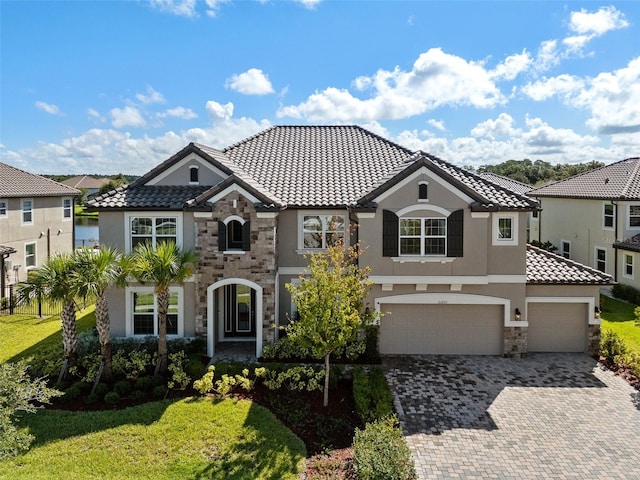 33255 Kateland Dr, Wesley Chapel, FL 33545 - view of front of property with stone siding, stucco siding, a tile roof, driveway, and an attached garage